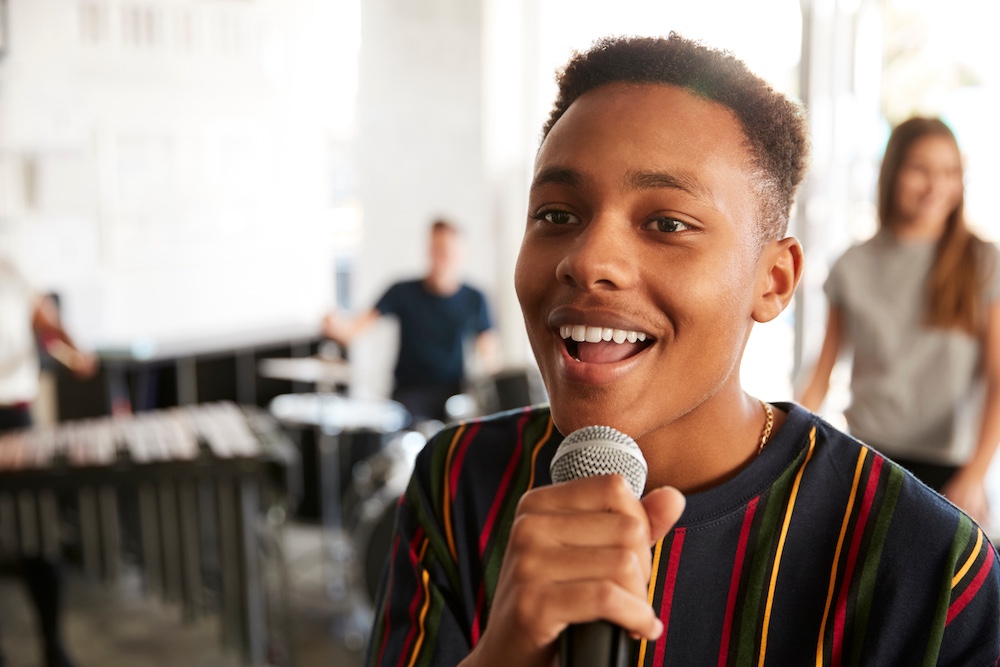 Student singing into a microphone