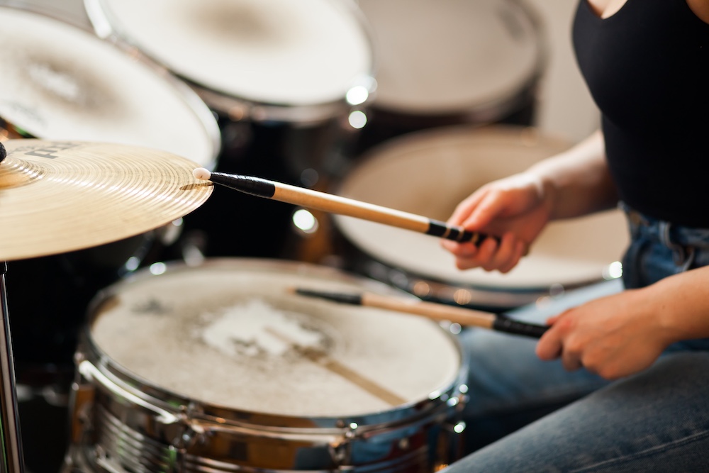 Drumsticks striking a cymbal